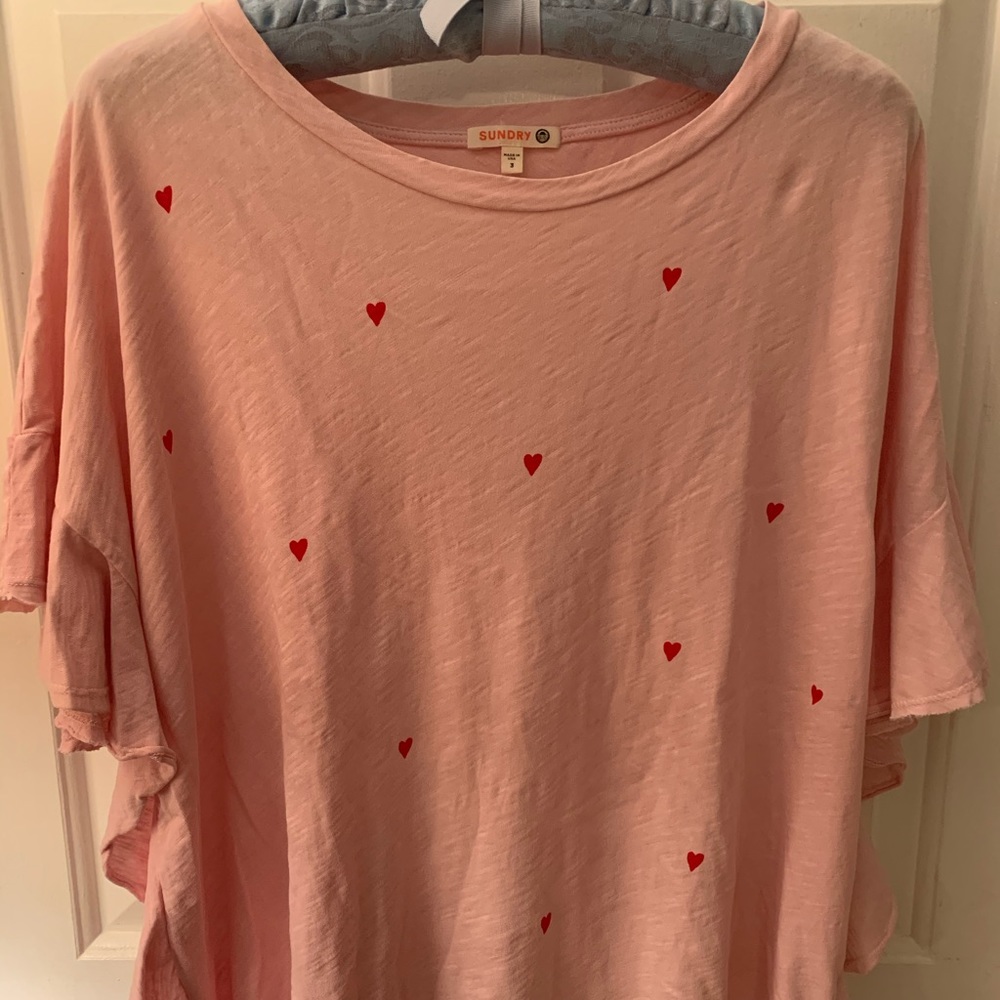 Pink top with red hearts.